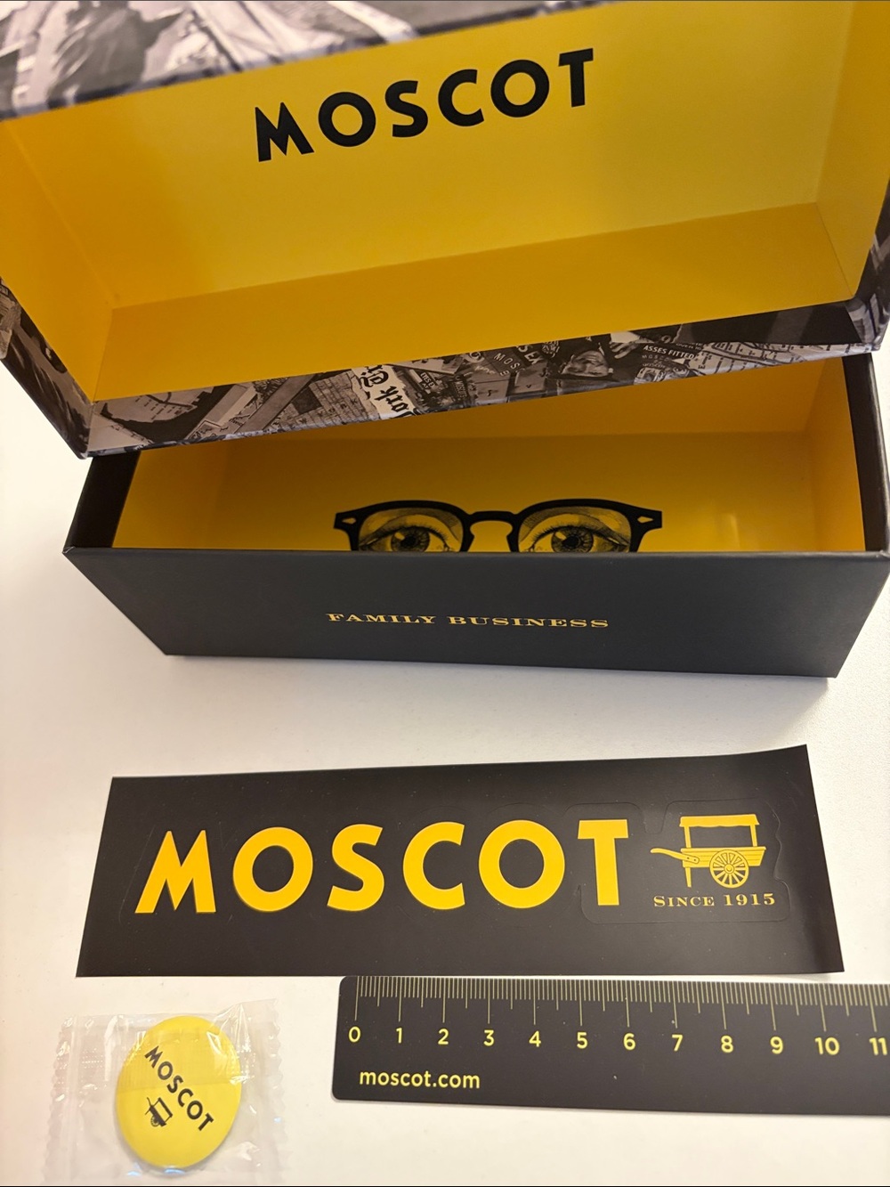 MOSCOT Yellow & Black Eyewear Box with Graphic, yellow Moscot pin and ruler